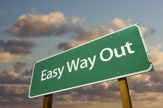 Easy Way Out Green Road Sign with dramatic clouds and sky.