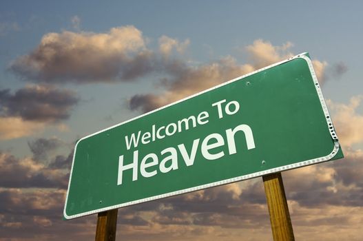 Welcome To Heaven Green Road Sign with dramatic clouds and sky.