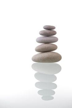 Pyramid of stacked pebble stones with reflection. Zen concept.