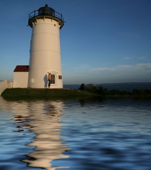 lighthouse reflected in water