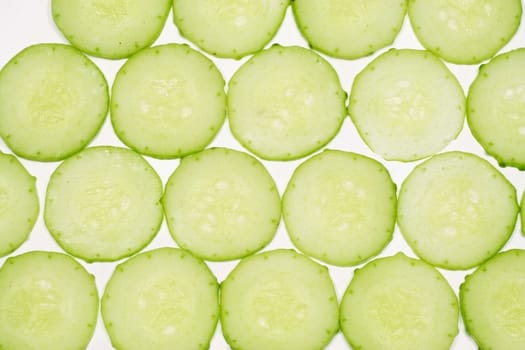 Thinly sliced cucumber on a white background