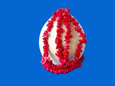 Wooden egg for easter and colorful coral gems. Macro.