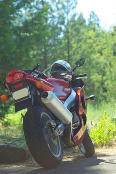 Red sportbike taking a break while crusing the high mountain forest roads.