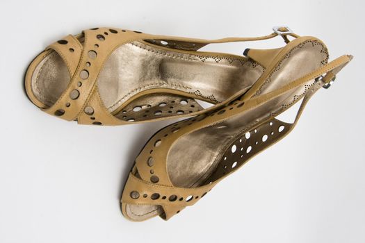 pair of light brown high heel shoe on white