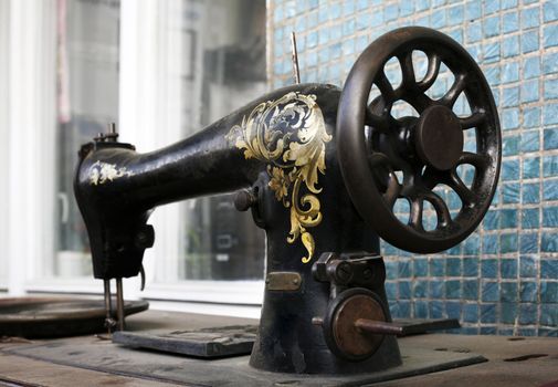 This shows the hand painted detail of an old sewing machine