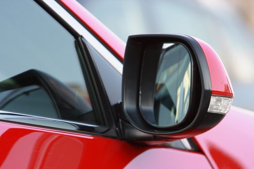 rear-view mirror by the red sports machine

