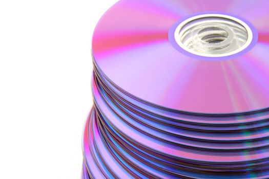 Stacked colorful DVDs or CDs isolated on white background. No dust.