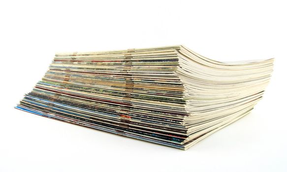 Stack of old thin magazines on white background.
