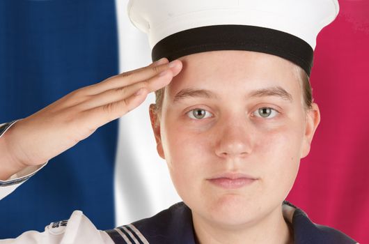 young female sailor saluting in front of french flag