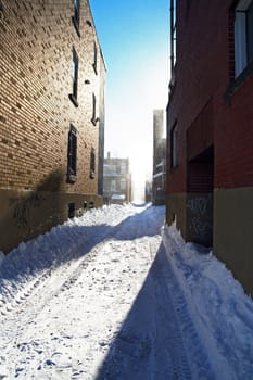 Sunny day after the snowstorm. Urban street covered by snow.