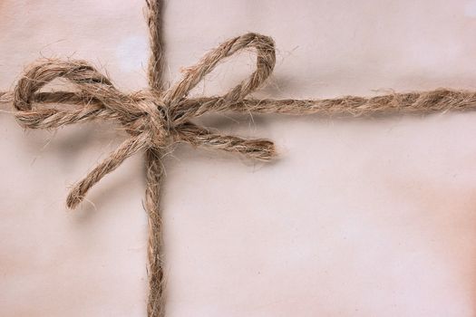 The ancient package is tied by a cord with a bow.