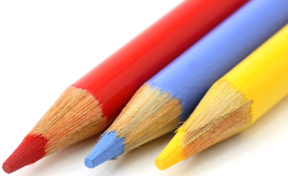 Pencil crayons, red, blue yellow primary colors angled