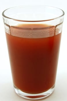Glass of fresh tomato juice, isolated on white