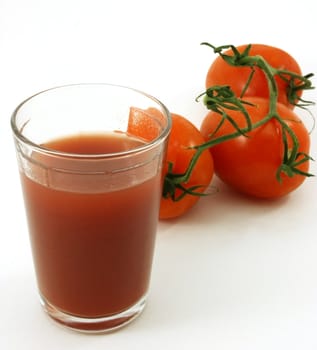 Tomato juice and tomatoes in background