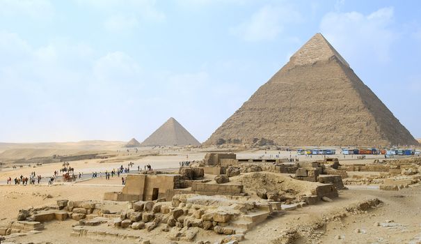 egypt, landscape with three pyramids and tourist under blue sky