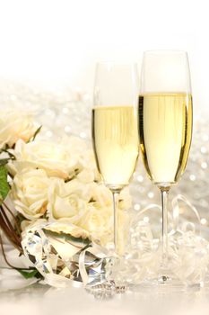 Champagne glasses ready for wedding festivities with roses