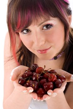 Portrait of seductive young woman holding fresh cherries in a hand