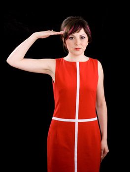 Saluting petite young woman in red dress