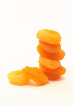 Stack of ginger dried apricots isolated on white background