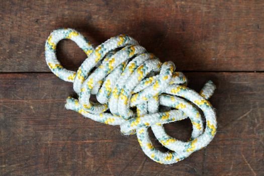Closeup of rope skein lying on wooden background