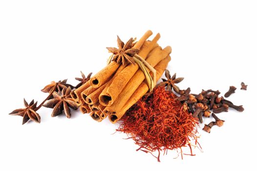 Dry cinnamon sticks and spice on white background
