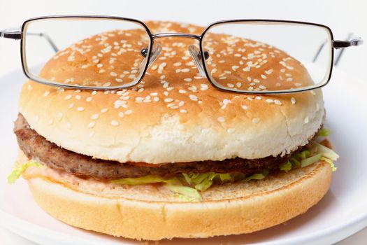 Jolly clever sandwich with glasses on a plate