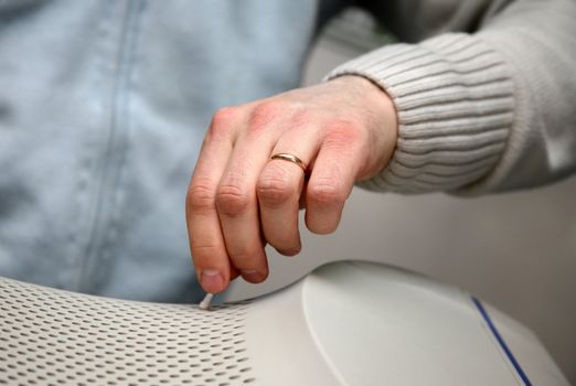 The man cleans a surface of the monitor