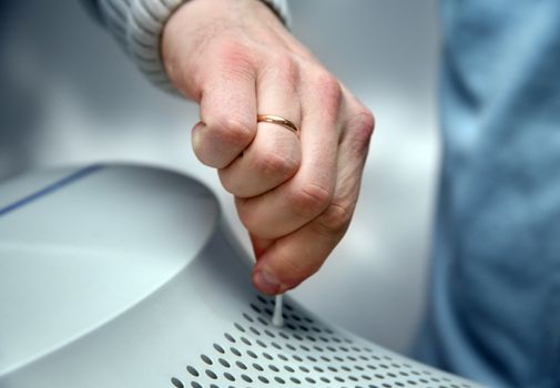 The man cleans a surface of the monitor