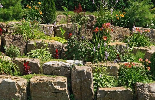 Flowering garden, decorated with stones.