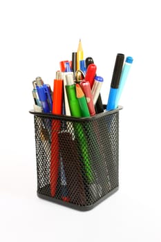 Black metal pencil cup filled with colorful used pencils and pens, isolated