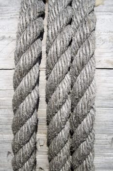 Gray boat rope on wooden background.
