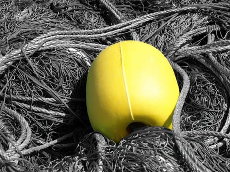 image of a yellow buoy among ropes