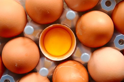 A set of brown eggs in a plastic tray