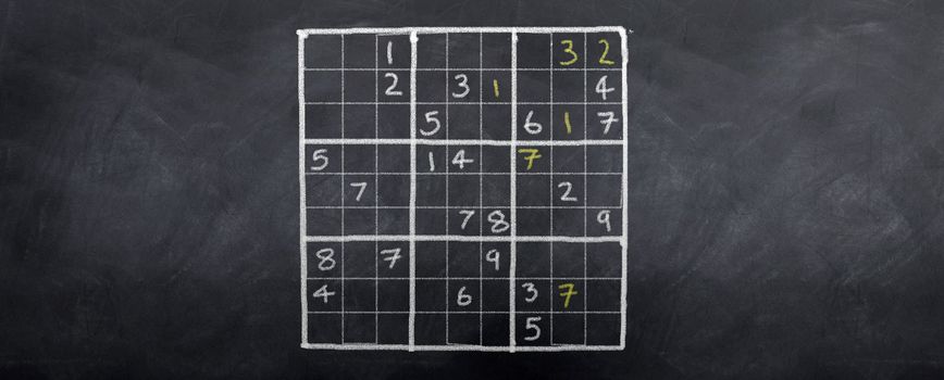 A game of sudoku played on a blackboard