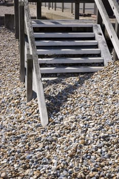 A pebble beach with wooden steps