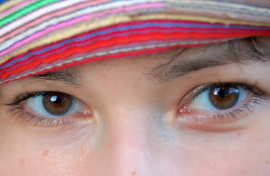 close-up of eyes of attractive young women in colorful hat