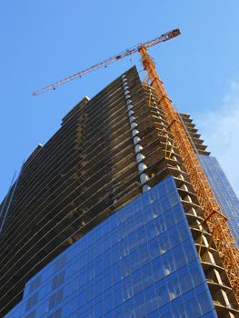 A crane and skyscraper building under construction