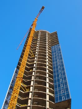 A crane and skyscraper building under construction