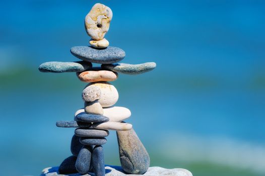 Balance of pebble as figurines on the background the sky