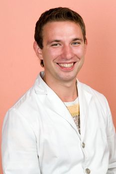 young smiling man in a white doctor's smock