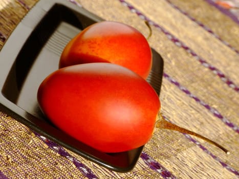 Close-up of two ripe tamarillos