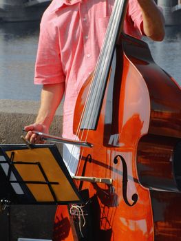 Double-bass street player performing jazz