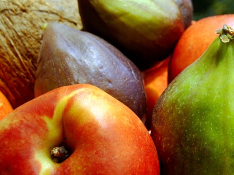 Close-up of fresh mixed fruit: coconut, peaches and figs