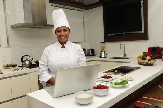 Happy chef cooking in kitchen