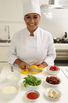 Professional chef cutting yellow pepper