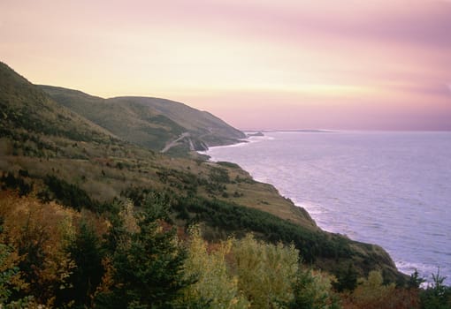 Sun sets over the beautiful Cabot Trail in Cape Breton, Nova Scotia - a famous tourist destination.