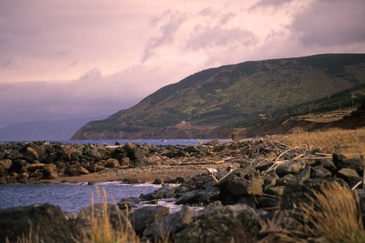 The sun sets over the mountains of the Cape Breton Highlands, National Park in Nova Scotia, Canada.