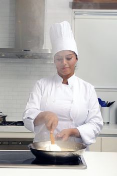 Chef cooking risotto stirring with ladle