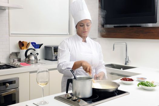 Chef cooking risotto stirring with ladle