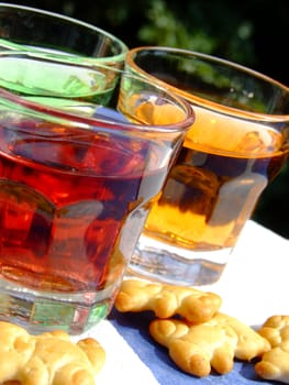 Close-up of three mini drinks and some snacks